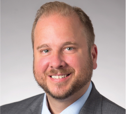 Headshot photo of Adam Zeidler smiling